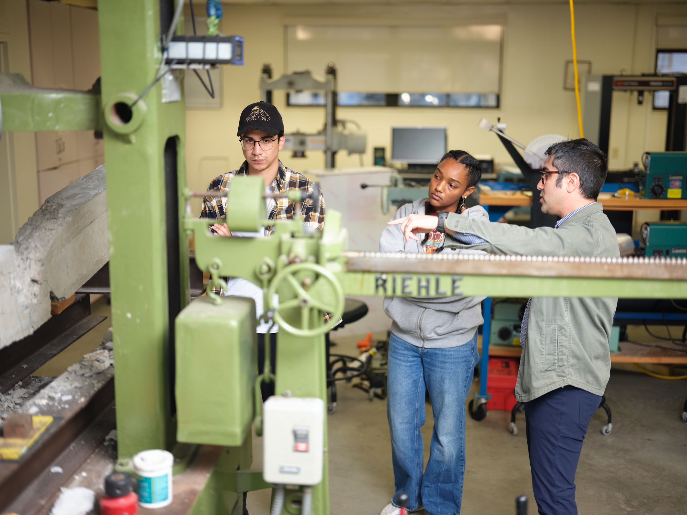 Students and faculty discussing an experiment in the structural engineering laboratory